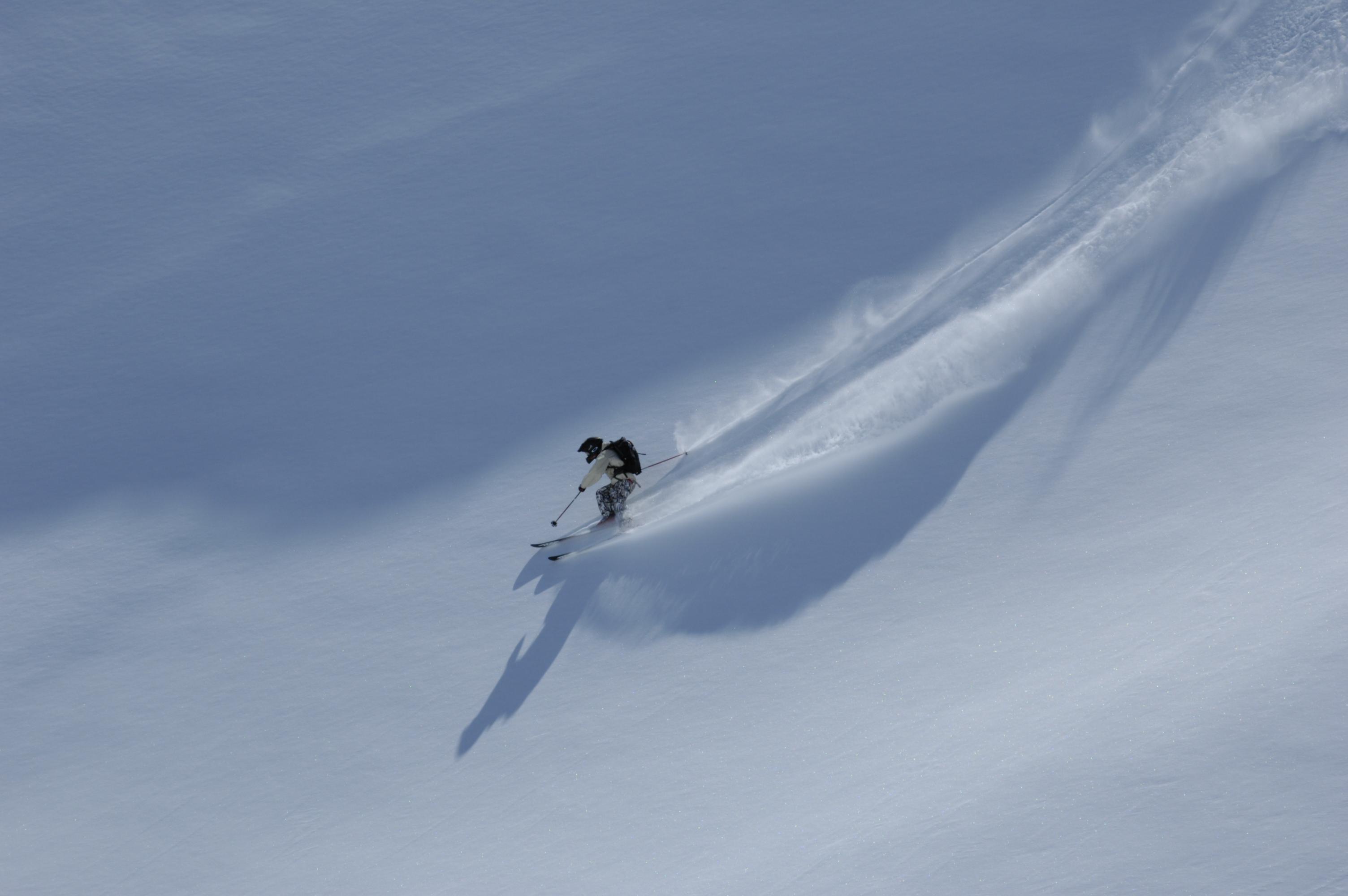 Skiier skiing down off piste slope